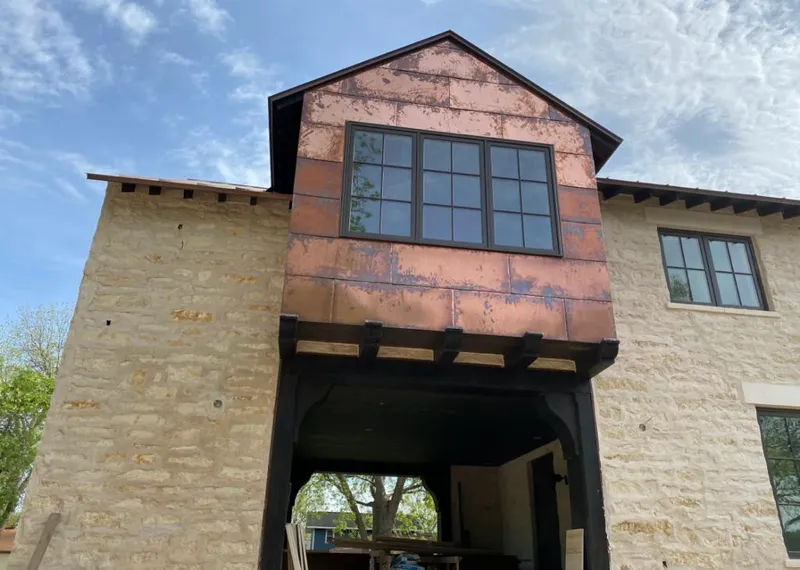 Copper metal panel facade on a stone building for Skylight Installation in Williams